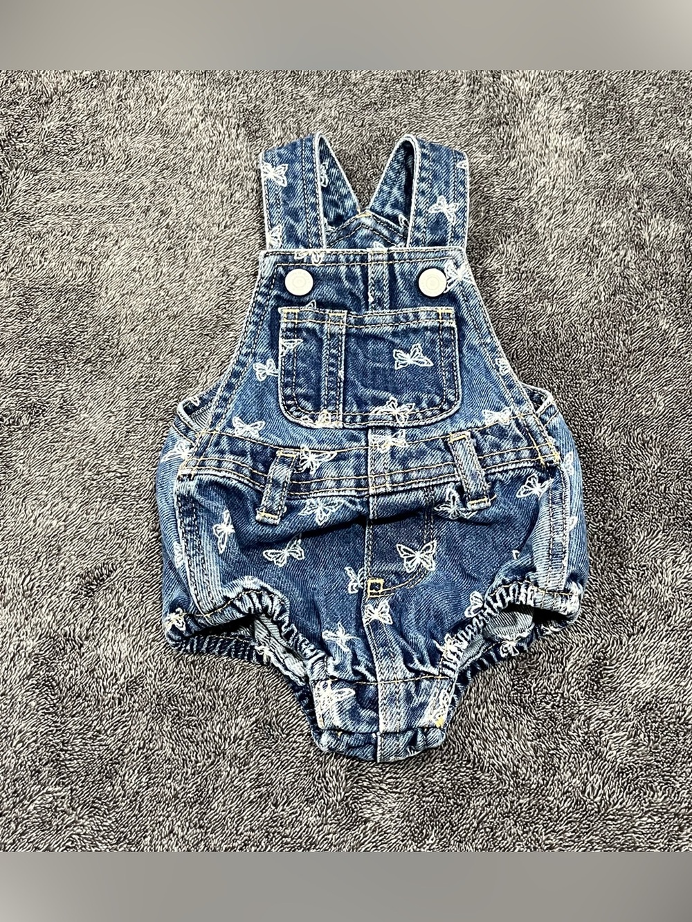 Old Navy jean romper for babies features an all-over white butterfly print 0-3